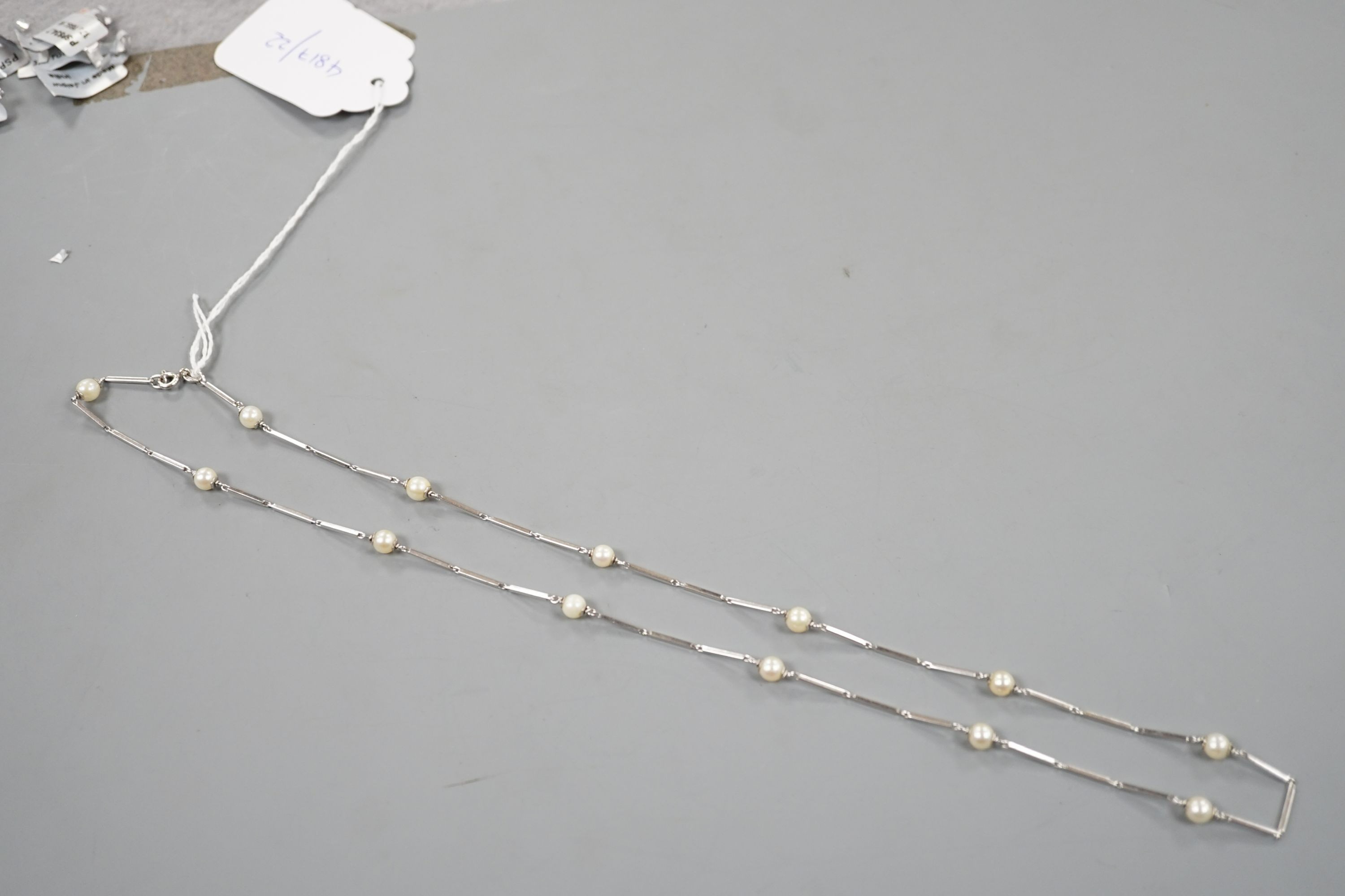 A modern Italian 750 white metal baton link and cultured pearl set necklace, 58cm, gross weight 12.7 grams.